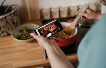 Person cooking meal while using Oviva app
