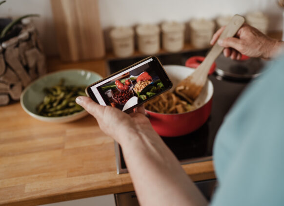 Person cooking meal while using Oviva app