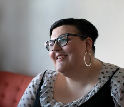 Overweight woman on a couch smiling