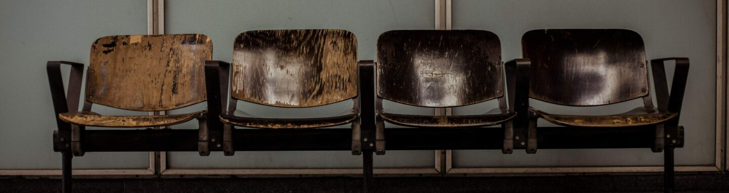 Four brown chairs in a waiting room