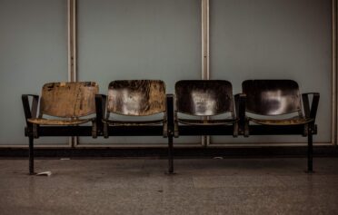 Four brown chairs in a waiting room
