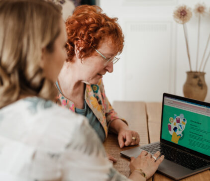 Two women using weight loss programme online