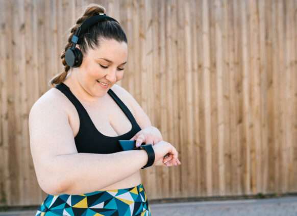 Woman in exercise wear checking her smartwatch