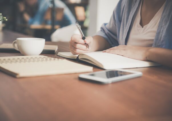 Woman writing in notebook