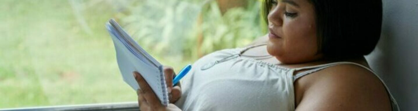 Woman writing in notebook