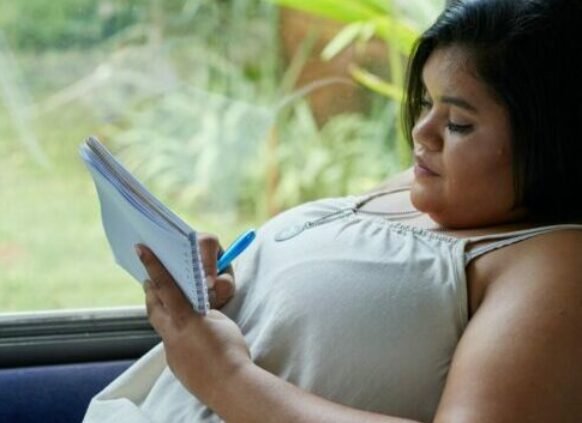 Woman writing in notebook