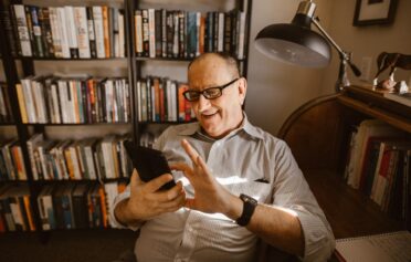 Man looking at phone and laughing