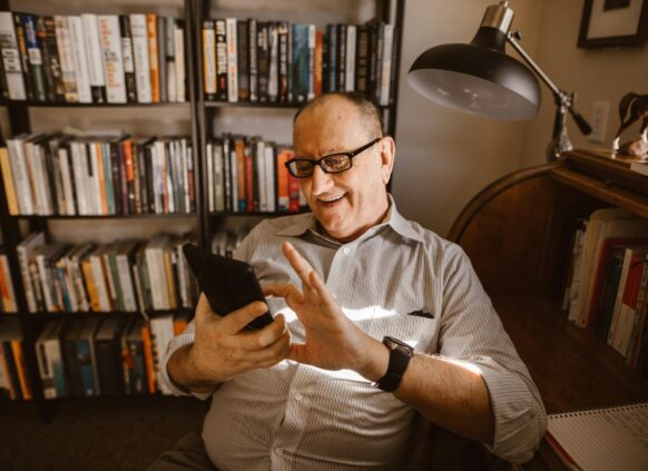 Man looking at phone and laughing