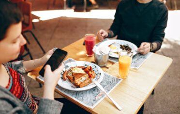 Two people eating breakfast at a restaurant