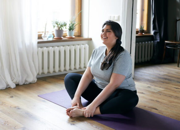 Woman stretching on exercise mat