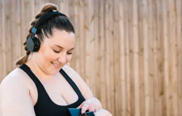 Woman in exercise wear checking her smartwatch